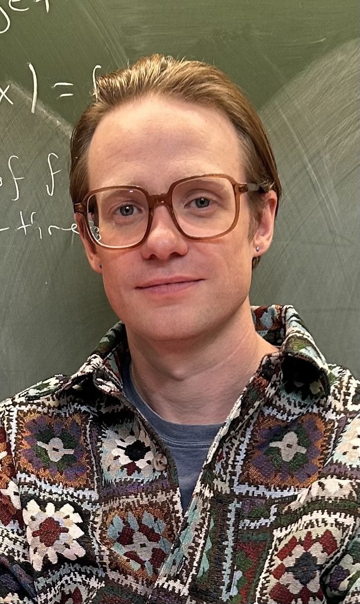 Robert Robere in front of a chalkboard